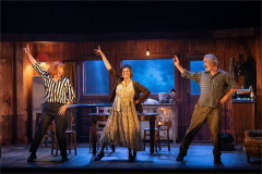 Three actors dancing in a wood-panelled seaside cottage in The Children at the Lyric Hammersmith. Photo by Helen Maybanks